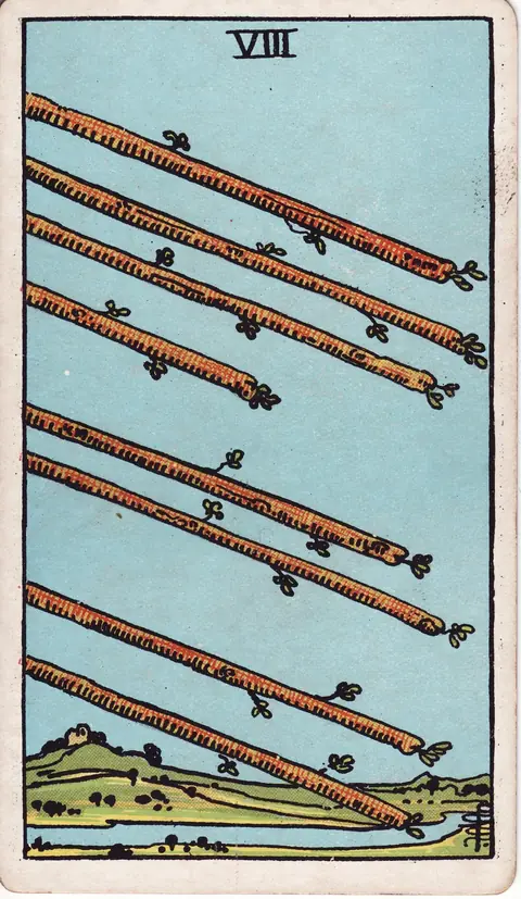 Eight leafy wands flying diagonally across a clear sky above a river and green countryside