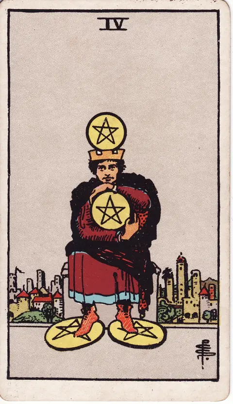 A crowned man sits before a city, clutching a pentacle to his chest with another above his head and two beneath his feet.