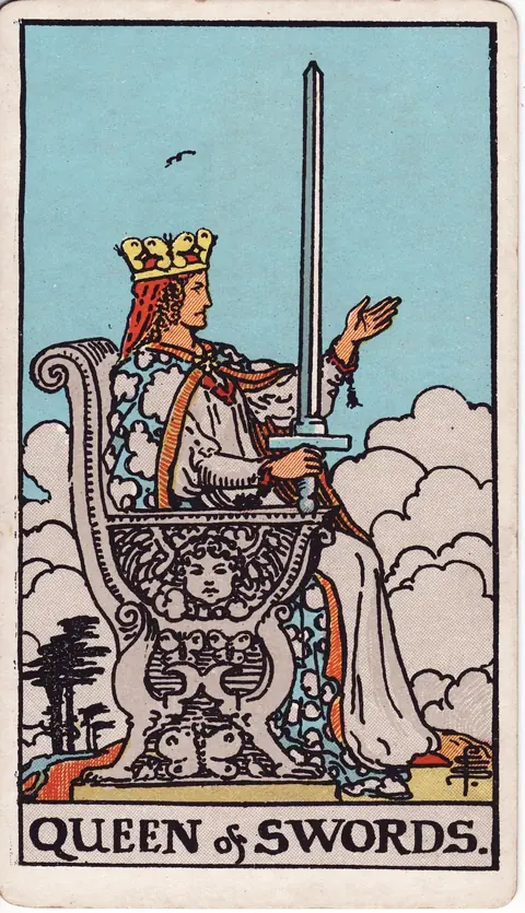 The Queen sits on a carved throne with a sword raised in her right hand and her left hand extended beneath a clear sky.