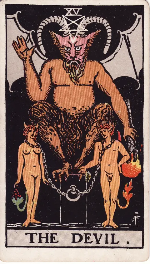 A horned Devil above a man and woman whose loose chains attach to a dark pedestal