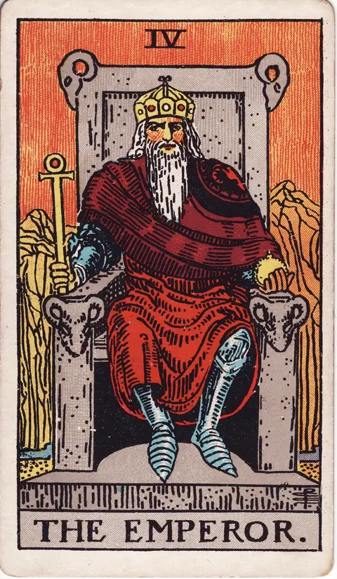 The Emperor seated on a stone throne with ram heads, holding an ankh sceptre and an orb