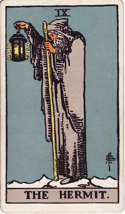 The Hermit in a grey cloak on a snowy height, holding a lantern with a six-pointed star and a staff