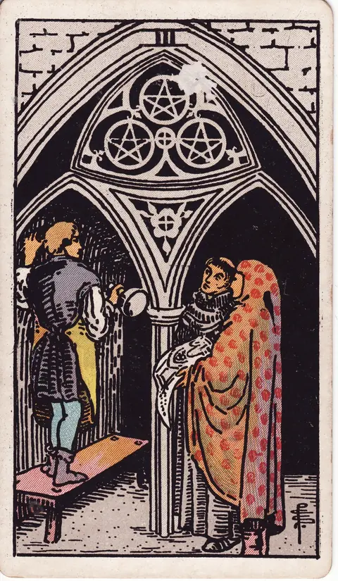 A craftsperson works on a stone arch bearing three pentacles while two figures stand nearby with a plan.