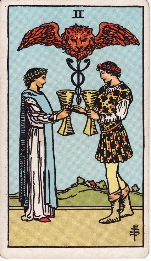 A man and woman exchange cups beneath a winged lion's head and the caduceus of Hermes, with a house on a green hill behind them.