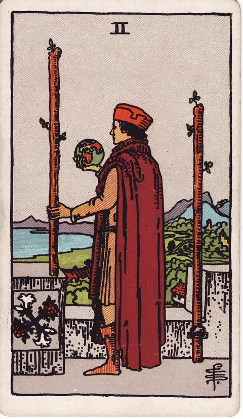 A man on castle battlements holding a globe between two wands and looking over land and sea