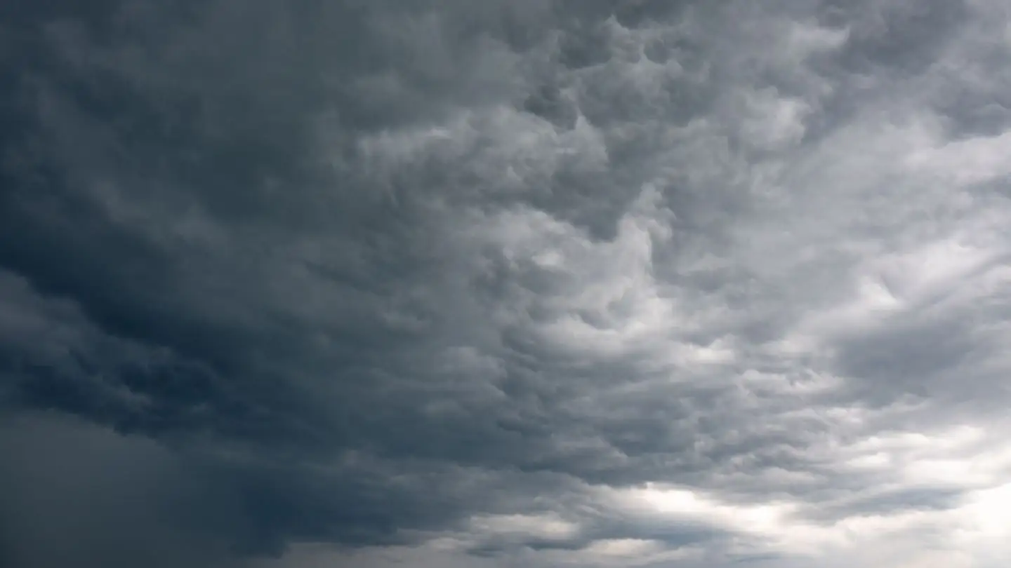 Dark storm clouds gather across the sky.