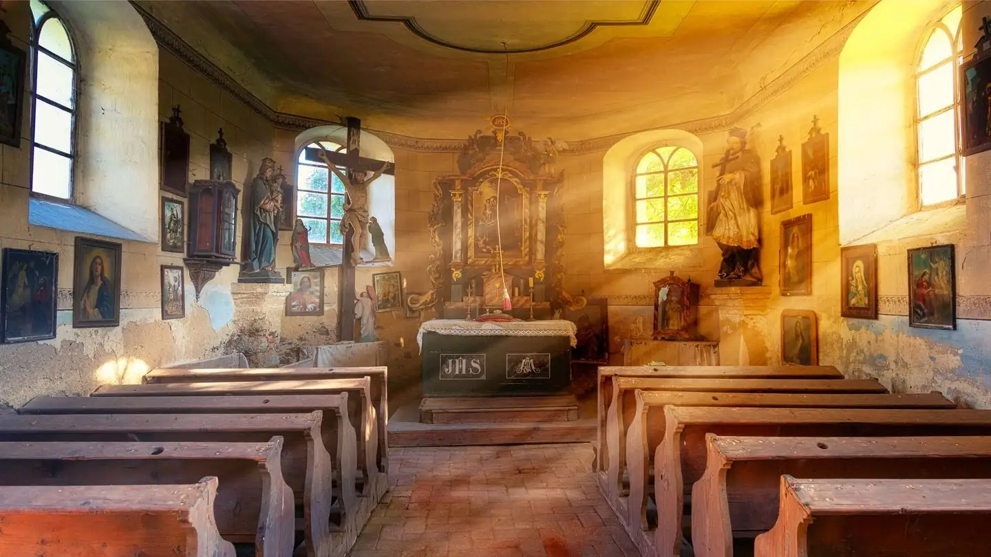 Sunlight falling through windows into a church with rows of wooden pews