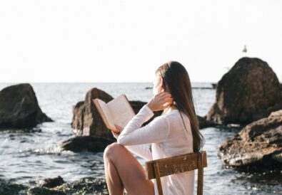 Woman sitting with one foot in the water